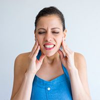 women opening and closing her jaw